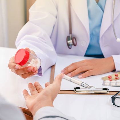 Doctor handing patient pills